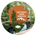 US National Park Service logo on a forest background