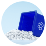 Blue recycling bin with shredded paper spilling out